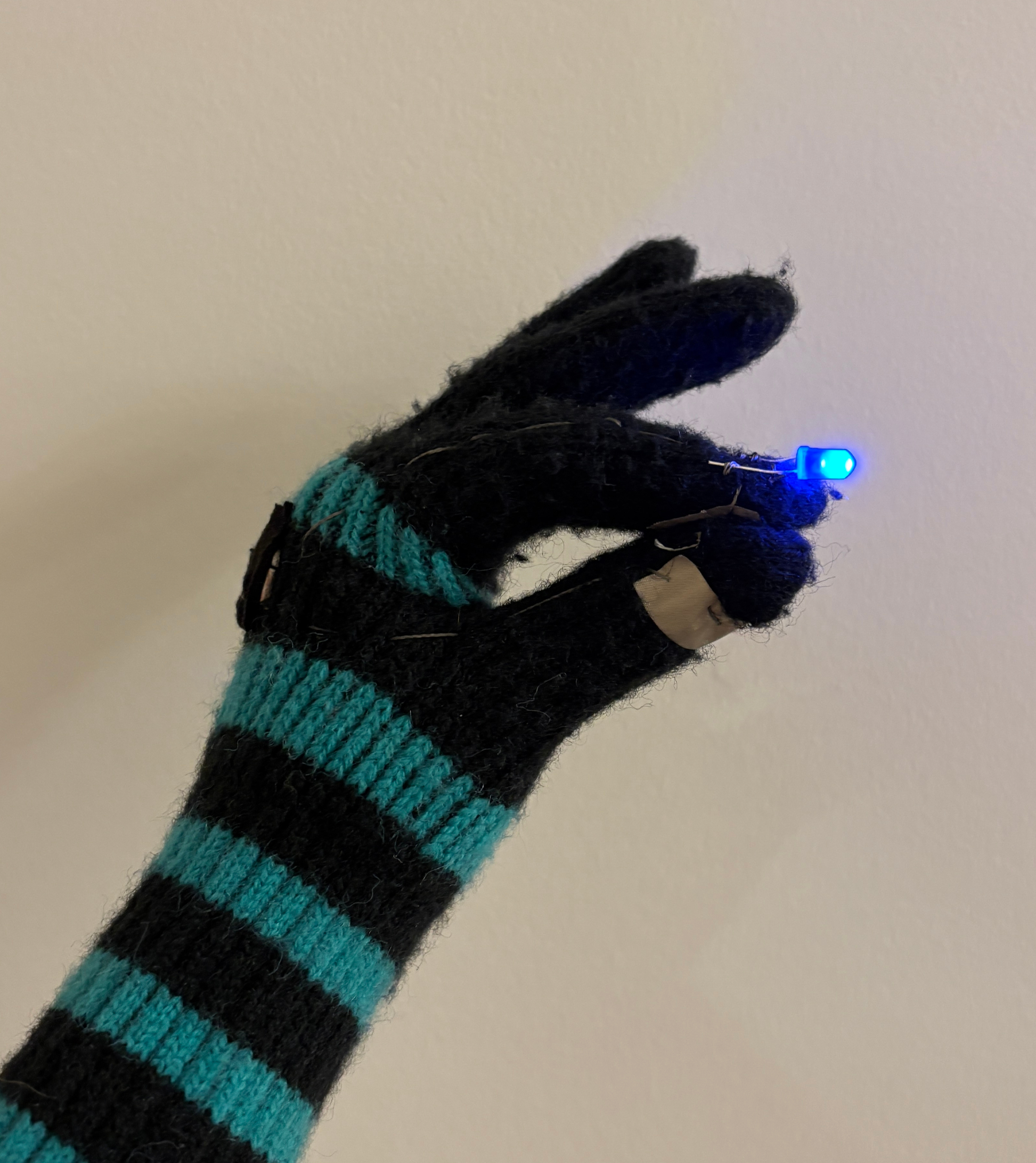 I used mainly conductive thread and fabric to create the circuit that is interconnected within the gloves fabric. The thread runs through the thumb and index finger, each connected to a different side of the battery. The circuit can be closed by touching the conductive fabric on the index and thumb, therefore activating the light.