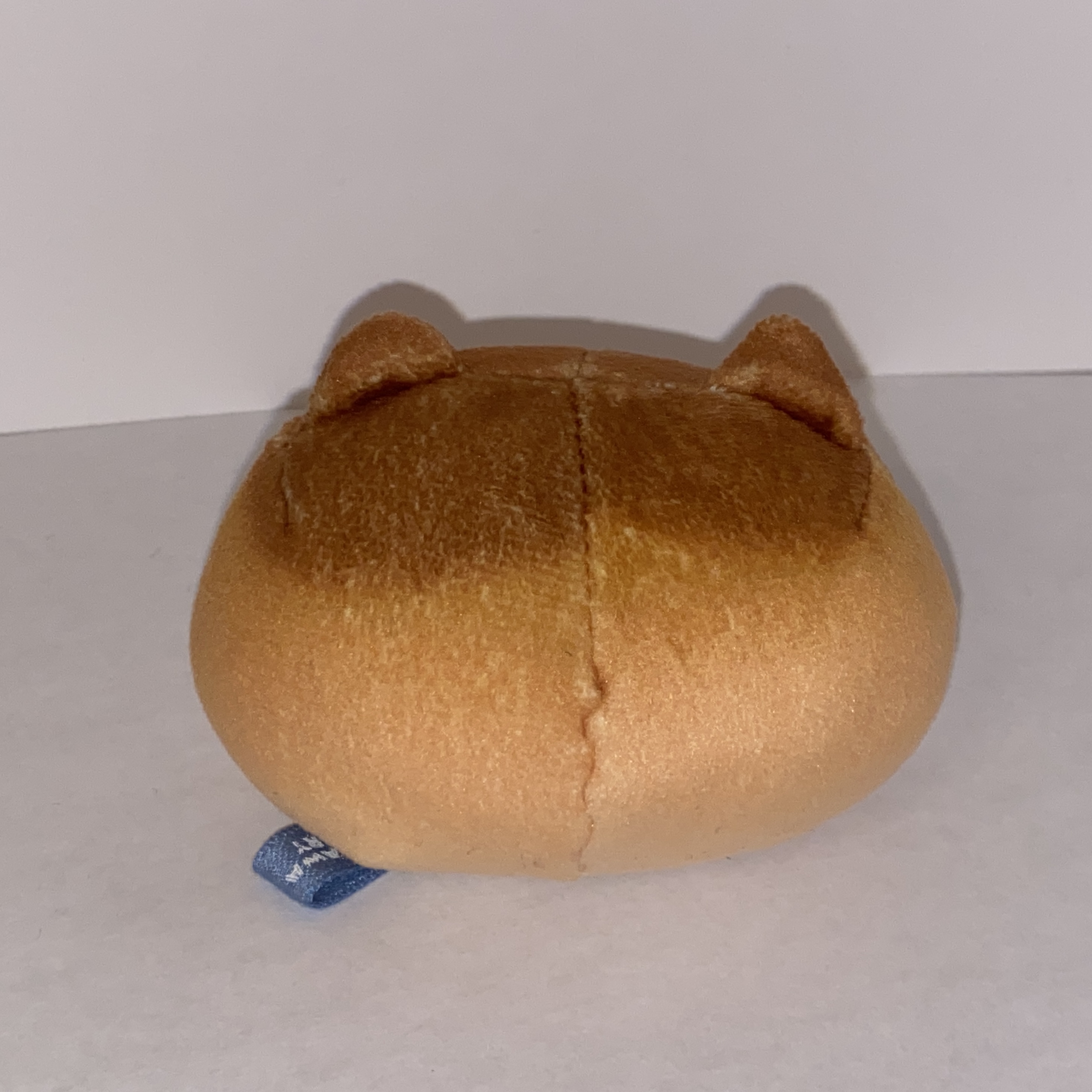Image of a small round plushie.