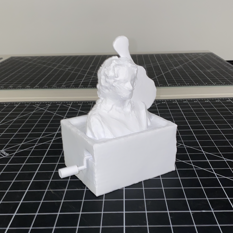 3D print depicting my concept which utilize my collaging process to represent various aspects of myself. The base is a music box I got when I was younger, which represents my love for music and how it has been a huge part of my life since I was young. On top of the music box is myself, which connects me to these objects. On the right side of me, is a guitar. A guitar is an instrument that I have been playing for years, and therefore has a lot of meaning in terms of communicating who I am and relating it to my own self-expression. Overall, this 3D print captures the essence of who I am through the lens of music and self-expression.